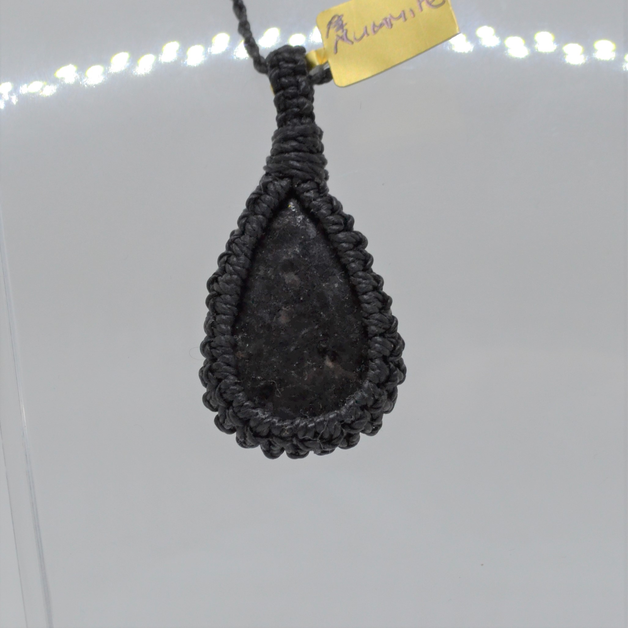 Nuumite pendant in dark knotwork