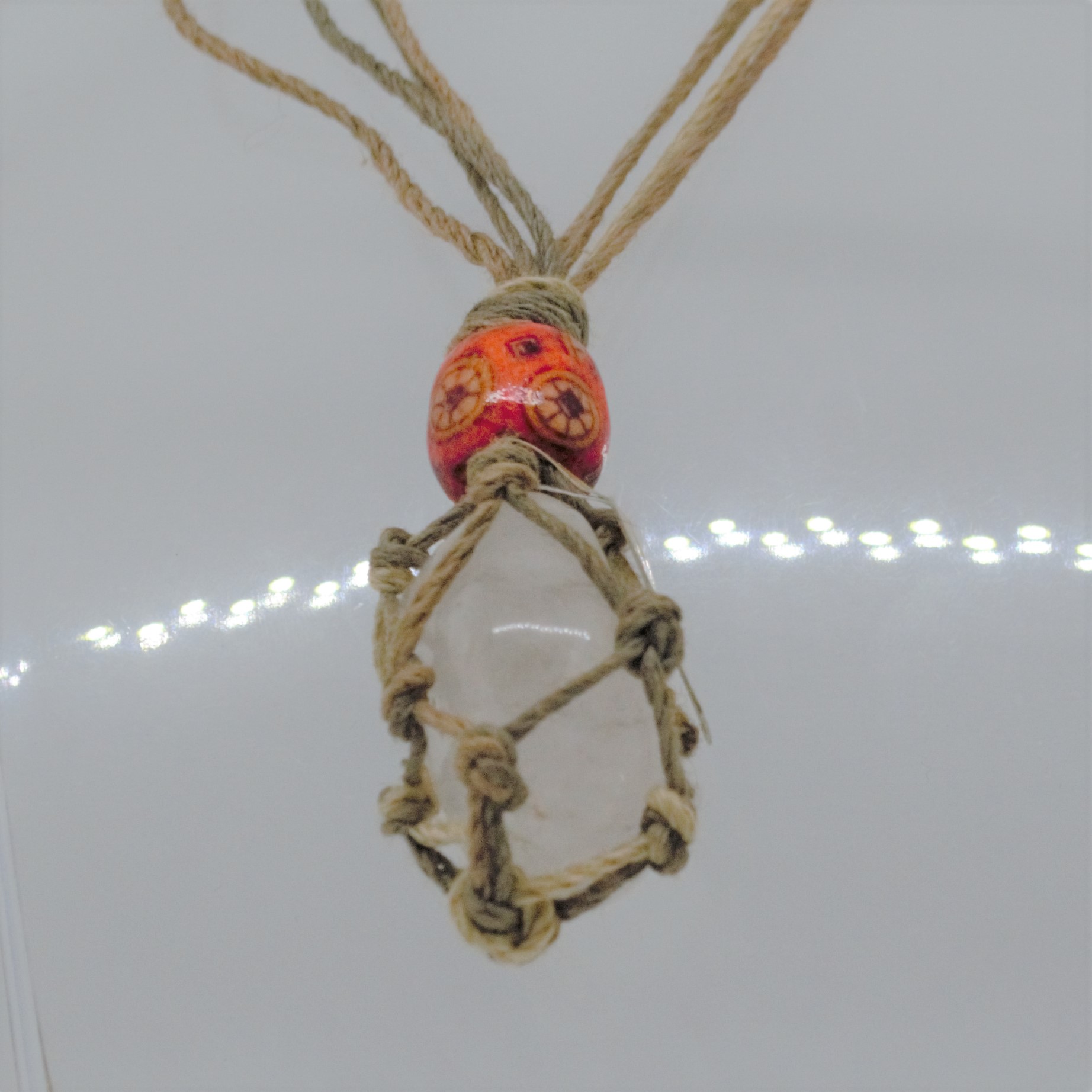 Rock quartz pendant in natural cord